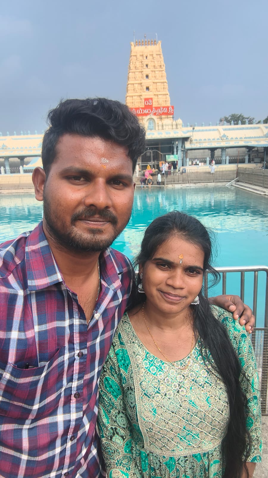 Sai Gopi and Sirisha at a temple